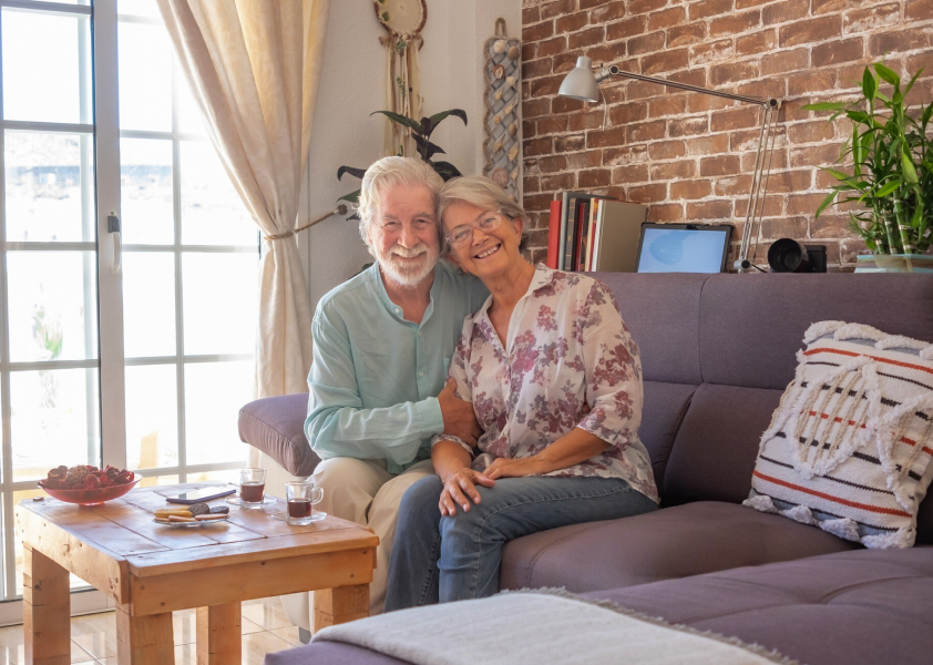 Elderly couple sitting on a couch together