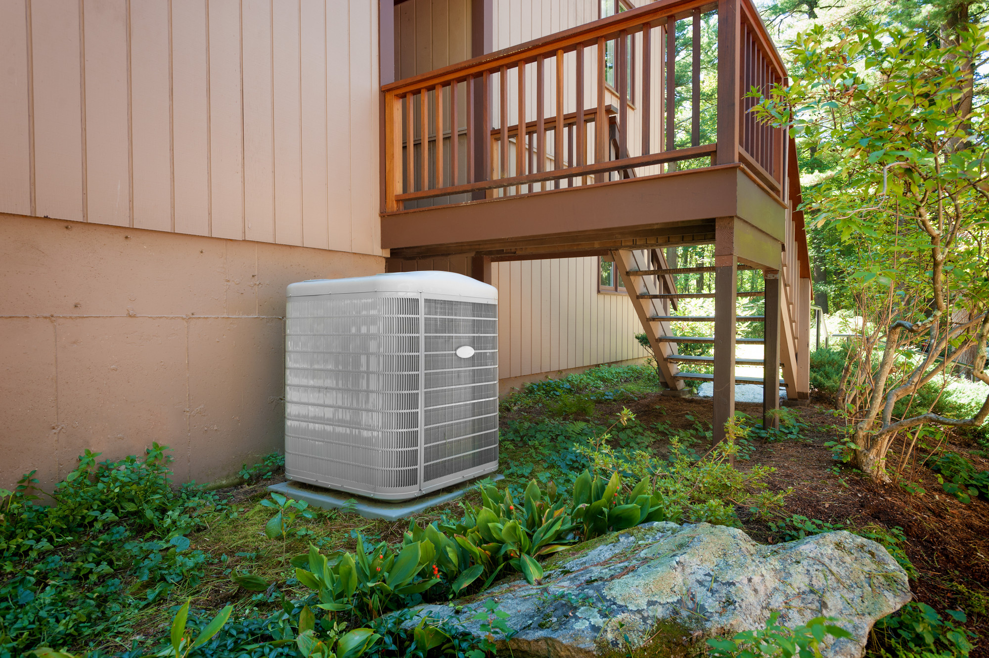 A new central air conditioning and heating unit sitting outside a home.