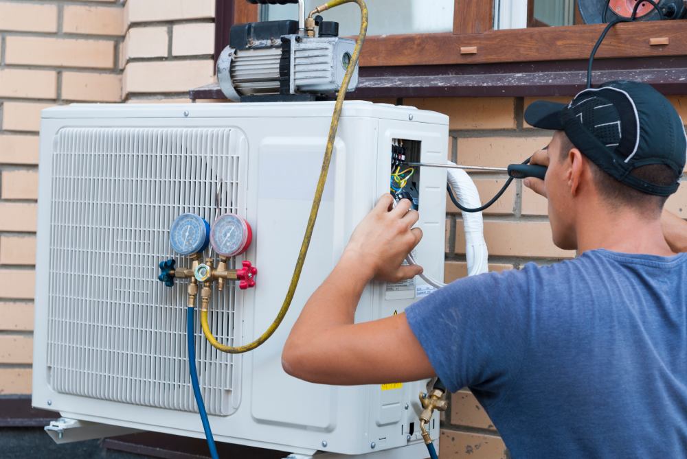 A man fixes a heat pump cooling a home