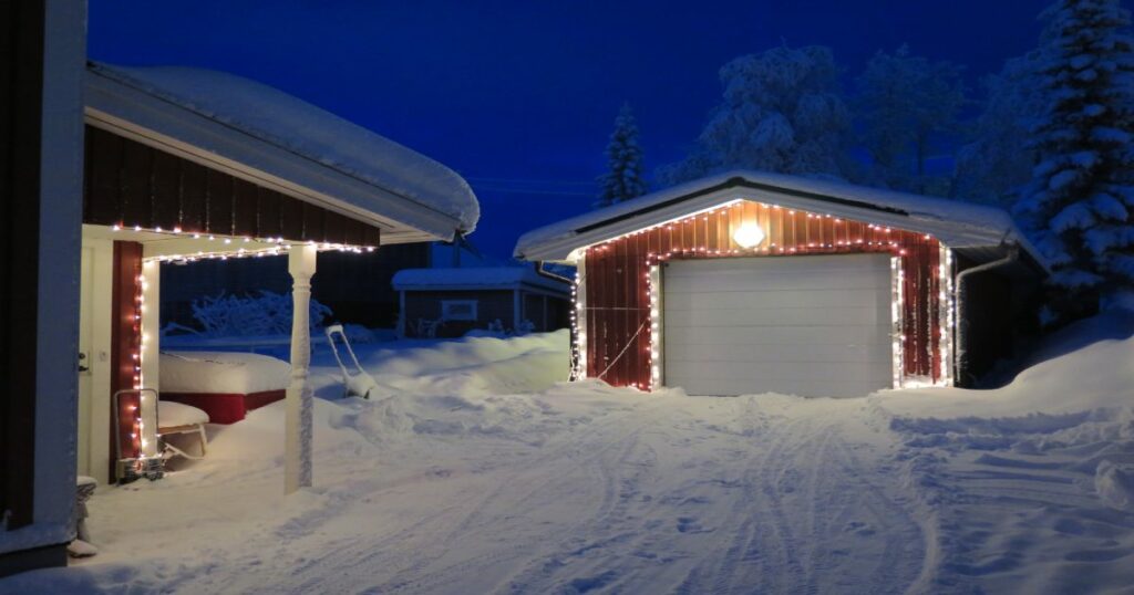 A snow covered detached garage