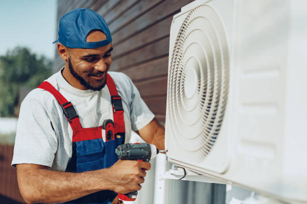 Technician installing heat pump